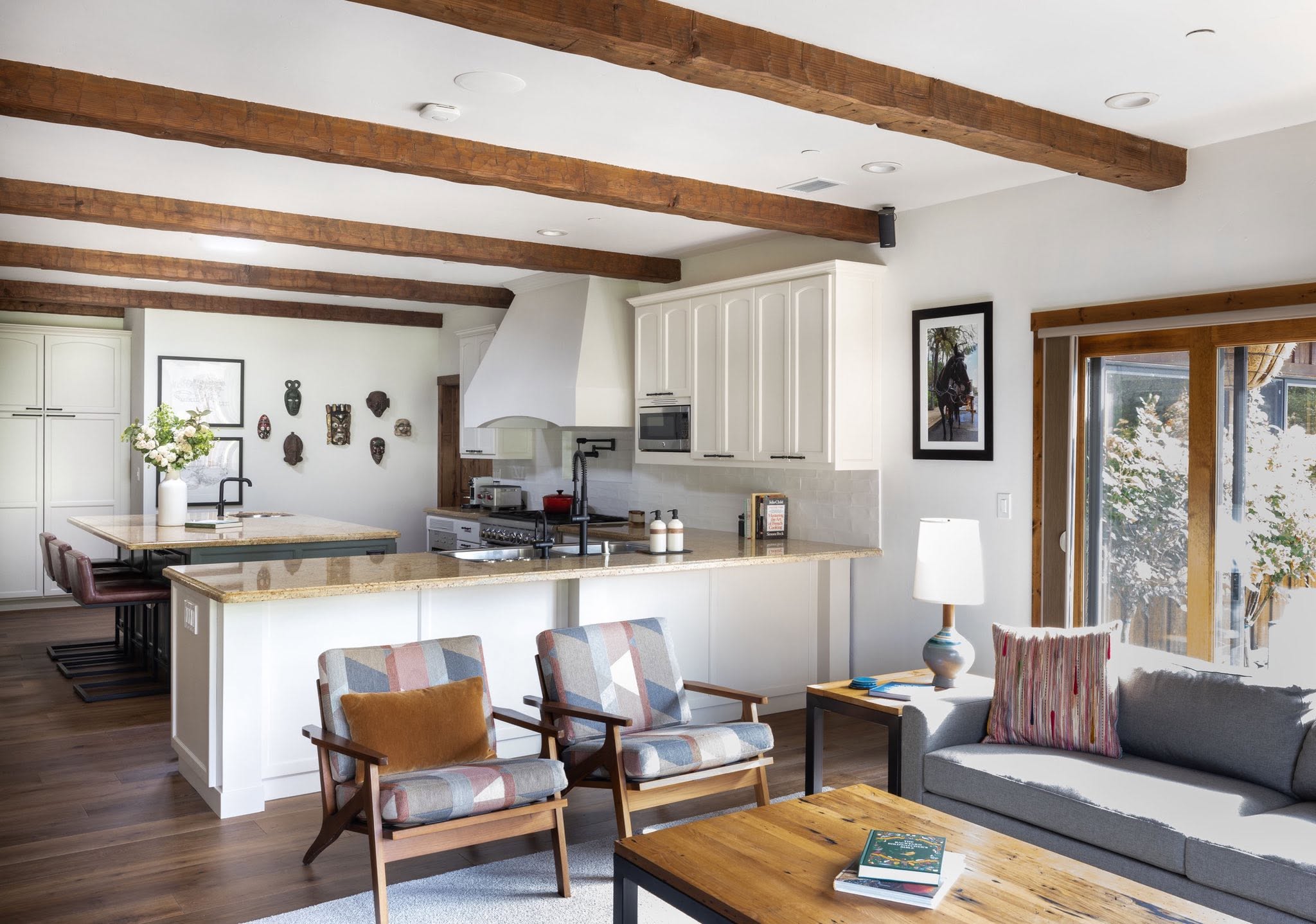 Open kitchen and living room with warm wood beams